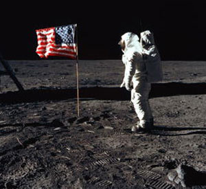 A man on the moon looking at the US flag